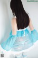 A woman in a blue and white dress is posing for a picture.
