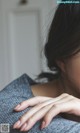 A close up of a woman's hand on her shoulder.