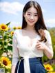 A woman standing in front of a field of sunflowers.