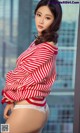 A woman in a red and white striped sweater posing for a picture.