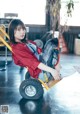 A woman sitting on top of a yellow cart.